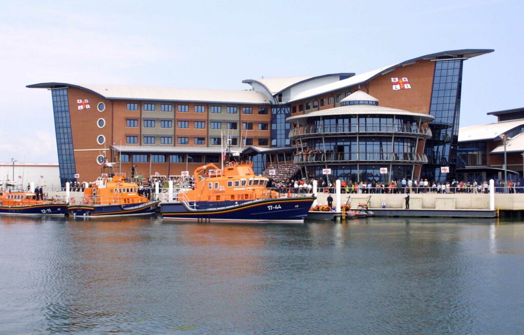 Poole Lifeboat College at the official opening for HM The Queen's visit. Crowds gathering in the background. In the foreground is the Severn all weather lifeboat 17-44, ON 1277 (Annette Hutton).