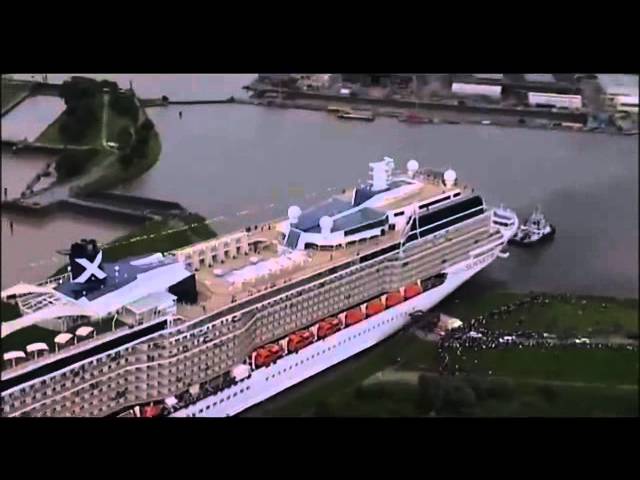 Giant ship squeezes through tiny canal